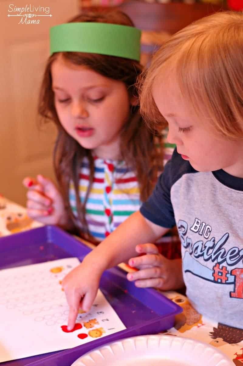 Kids finger painting apples