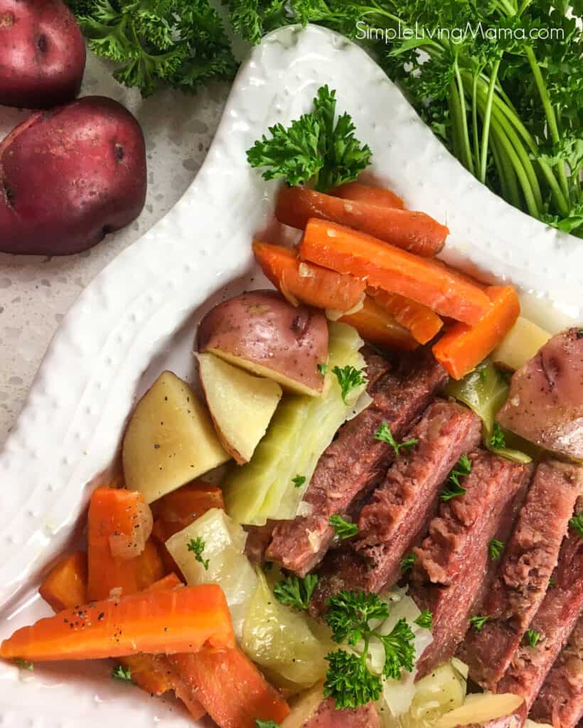 Serving tray of Instant Pot corned beef and cabbage