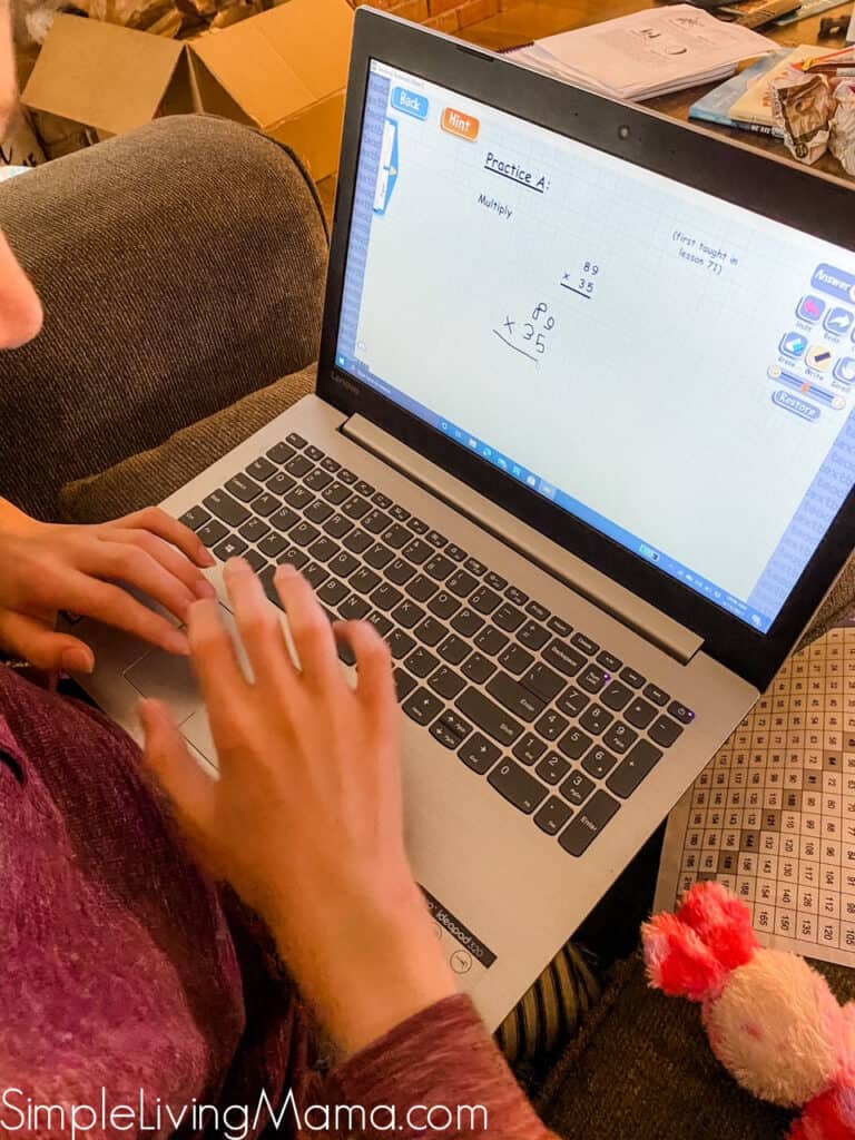 Homeschooled child using Teaching Textbooks Math 5 scratchpad.